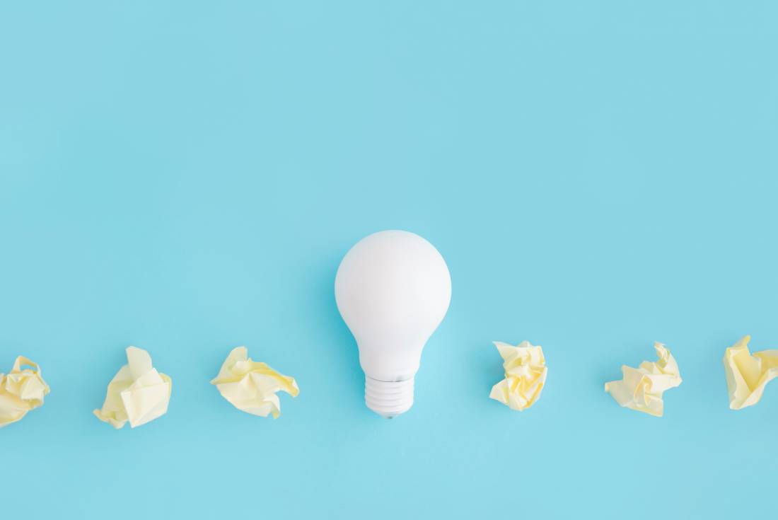 white-light-bulb-with-yellow-crumpled-paper-colored-background-